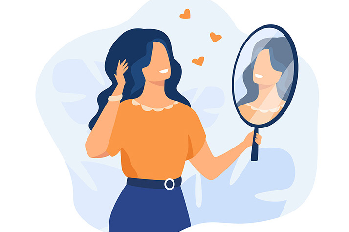 Happy woman looking at herself in mirror